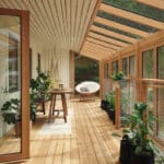 Helle Holzveranda mit Pflanzen und Glasdach